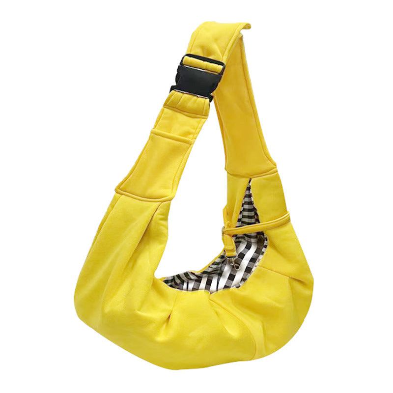 Adjustable Dog Out Pet Bag in bright yellow polyester with a soft sling shape, adjustable strap, and plaid-lined opening
