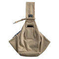 Pet Dog Travel Sling in soft beige fabric with a solid finish, adjustable strap, and front phone pocket