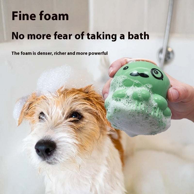Pets Shower Brush in green silicone with a cute animal face, dispensing thick foamy lather during a dog bath.